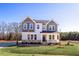 Two-story home with gray siding, stone accents, and a front porch at 5017 Trotter Dr, Raleigh, NC 27603