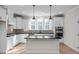 Modern kitchen with white cabinets, black countertops, and island at 5017 Trotter Dr, Raleigh, NC 27603