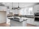 Modern kitchen with white cabinets, black countertops, and a large island at 5017 Trotter Dr, Raleigh, NC 27603