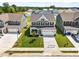 Aerial shot of a newly constructed two-story home with a manicured lawn and two-car garage at 8869 Tartan Clan Dr, Willow Springs, NC 27592