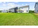 Spacious backyard featuring lush green grass, providing ample space for outdoor activities and relaxation at 8869 Tartan Clan Dr, Willow Springs, NC 27592