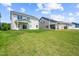 Large, grassy backyard with views of neighboring houses, perfect for outdoor activities and relaxation at 8869 Tartan Clan Dr, Willow Springs, NC 27592