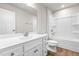 A bright bathroom with a shaker vanity, tub and shower combo, toilet, and large mirror at 8869 Tartan Clan Dr, Willow Springs, NC 27592