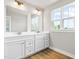 Bright bathroom featuring double sink vanity, shaker cabinets, quartz countertop, and luxury vinyl floor at 8869 Tartan Clan Dr, Willow Springs, NC 27592