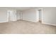 Carpeted bedroom with a view into other rooms via doorways, painted in neutral colors at 8869 Tartan Clan Dr, Willow Springs, NC 27592