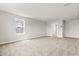 Bedroom with plush carpet and natural light coming from the window. Features an attached closet at 8869 Tartan Clan Dr, Willow Springs, NC 27592