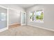 Bedroom with a large window showing a scenic outdoor view, with adjacent entry and an attached bath at 8869 Tartan Clan Dr, Willow Springs, NC 27592