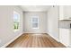Well-lit dining area boasts natural light and modern flooring, perfect for cozy Gathering meals at 8869 Tartan Clan Dr, Willow Springs, NC 27592