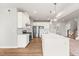 Well-lit kitchen featuring stainless steel appliances, a large island, and a view of the living room at 8869 Tartan Clan Dr, Willow Springs, NC 27592