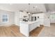 Bright kitchen with stainless steel appliances, white cabinets, and an island at 8869 Tartan Clan Dr, Willow Springs, NC 27592