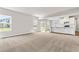 Spacious living area with an open floor plan, lots of natural light, and adjoining kitchen with bar seating at 8869 Tartan Clan Dr, Willow Springs, NC 27592