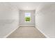 Spacious walk-in closet with ample shelving and a window offering natural light at 8869 Tartan Clan Dr, Willow Springs, NC 27592