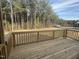 Relaxing back deck with wood floors and railing with views of the yard and surrounding trees at 135 Ironwood Blvd # 49, Youngsville, NC 27596
