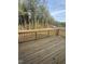 Relaxing back deck with wood floors and railing with views of the yard and surrounding trees at 135 Ironwood Blvd # 49, Youngsville, NC 27596