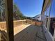 Back deck of new construction home with spacious floorboards and railings overlooking trees at 135 Ironwood Blvd # 49, Youngsville, NC 27596