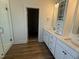 Bathroom featuring double sink vanity with granite counters, glass shower and modern fixtures at 135 Ironwood Blvd # 49, Youngsville, NC 27596