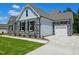 Beautiful two-story home featuring stone accents, a two-car garage, and well-maintained lawn at 135 Ironwood Blvd # 49, Youngsville, NC 27596
