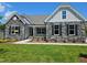 Charming stone-accented home with well-manicured lawn, sidewalk, and inviting covered porch at 135 Ironwood Blvd # 49, Youngsville, NC 27596