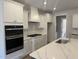 Modern kitchen with stainless steel appliances, white cabinets and granite countertops at 135 Ironwood Blvd # 49, Youngsville, NC 27596
