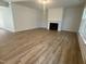 Large, open living room with hardwood floors and a cozy fireplace at 135 Ironwood Blvd # 49, Youngsville, NC 27596