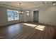 Bright living room featuring hardwood floors, stylish chandelier and large window at 135 Ironwood Blvd # 49, Youngsville, NC 27596
