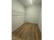 Spacious pantry featuring wooden floors and a white wire shelf for optimal organization and accessibility at 135 Ironwood Blvd # 49, Youngsville, NC 27596
