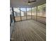 Enjoy the outdoors on this roomy screened porch, featuring wood flooring and scenic backyard views at 135 Ironwood Blvd # 49, Youngsville, NC 27596