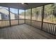 Screened-in porch has ceiling fan and views of the trees and backyard from the wood floors at 135 Ironwood Blvd # 49, Youngsville, NC 27596