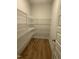 Walk-in closet with ample storage and custom shelving for optimal organization at 135 Ironwood Blvd # 49, Youngsville, NC 27596