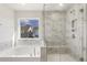 Elegant bathroom featuring a soaking tub, walk-in shower, and marble tile at 18 Steppe Way, Garner, NC 27529
