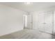 Bright bedroom with neutral decor, carpet, and double doors at 18 Steppe Way, Garner, NC 27529