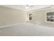 Spacious bedroom with carpeted floor, ceiling fan, and large windows at 18 Steppe Way, Garner, NC 27529