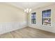 Spacious dining room with hardwood floors, wainscoting, and chandelier at 18 Steppe Way, Garner, NC 27529