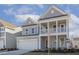 Two-story house with gray siding, white columns, and a two-car garage at 18 Steppe Way, Garner, NC 27529