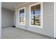 Covered front porch with gray siding and two windows at 18 Steppe Way, Garner, NC 27529