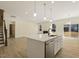 Island kitchen with stainless steel appliances and view to backyard at 18 Steppe Way, Garner, NC 27529