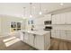 Spacious kitchen with white cabinets, quartz countertops and island at 18 Steppe Way, Garner, NC 27529