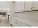 White kitchen cabinets, quartz countertops, and built-in shelving at 18 Steppe Way, Garner, NC 27529