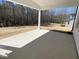 Covered patio overlooking a spacious, partially wooded backyard with tree line at 367 W Amber Oak Dr # 53, Selma, NC 27576