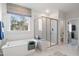 Bright bathroom with a tub, glass shower, and modern tile flooring at 367 W Amber Oak Dr # 53, Selma, NC 27576