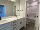 Bathroom with double vanity, white cabinets, and a shower-tub combo with tile surround at 367 W Amber Oak Dr # 53, Selma, NC 27576