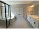 An elegant bathroom featuring a tub under a window, and a sleek dual vanity at 367 W Amber Oak Dr # 53, Selma, NC 27576
