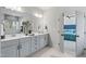 Bright bathroom featuring a double vanity, modern fixtures, and an adjoining bedroom at 367 W Amber Oak Dr # 53, Selma, NC 27576