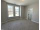 Bright bedroom with two large windows overlooking the outdoors and plush carpeting at 367 W Amber Oak Dr # 53, Selma, NC 27576