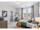 Bright bedroom features two windows, plush carpet and space-themed decor at 367 W Amber Oak Dr # 53, Selma, NC 27576