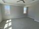 A bright bedroom features two sunny windows, soft carpeting, and a tray ceiling at 367 W Amber Oak Dr # 53, Selma, NC 27576