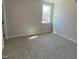 A well-lit bedroom featuring neutral walls and soft carpeting, complemented by a bright window at 367 W Amber Oak Dr # 53, Selma, NC 27576