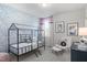Stylized bedroom with a black metal bed frame and modern patterned wallpaper at 367 W Amber Oak Dr # 53, Selma, NC 27576