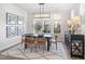 Elegant dining room with a modern chandelier, dark table, and natural light at 367 W Amber Oak Dr # 53, Selma, NC 27576