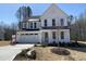 Charming two-story home featuring white siding, black accents, well-manicured landscaping, and a spacious two-car garage at 367 W Amber Oak Dr # 53, Selma, NC 27576